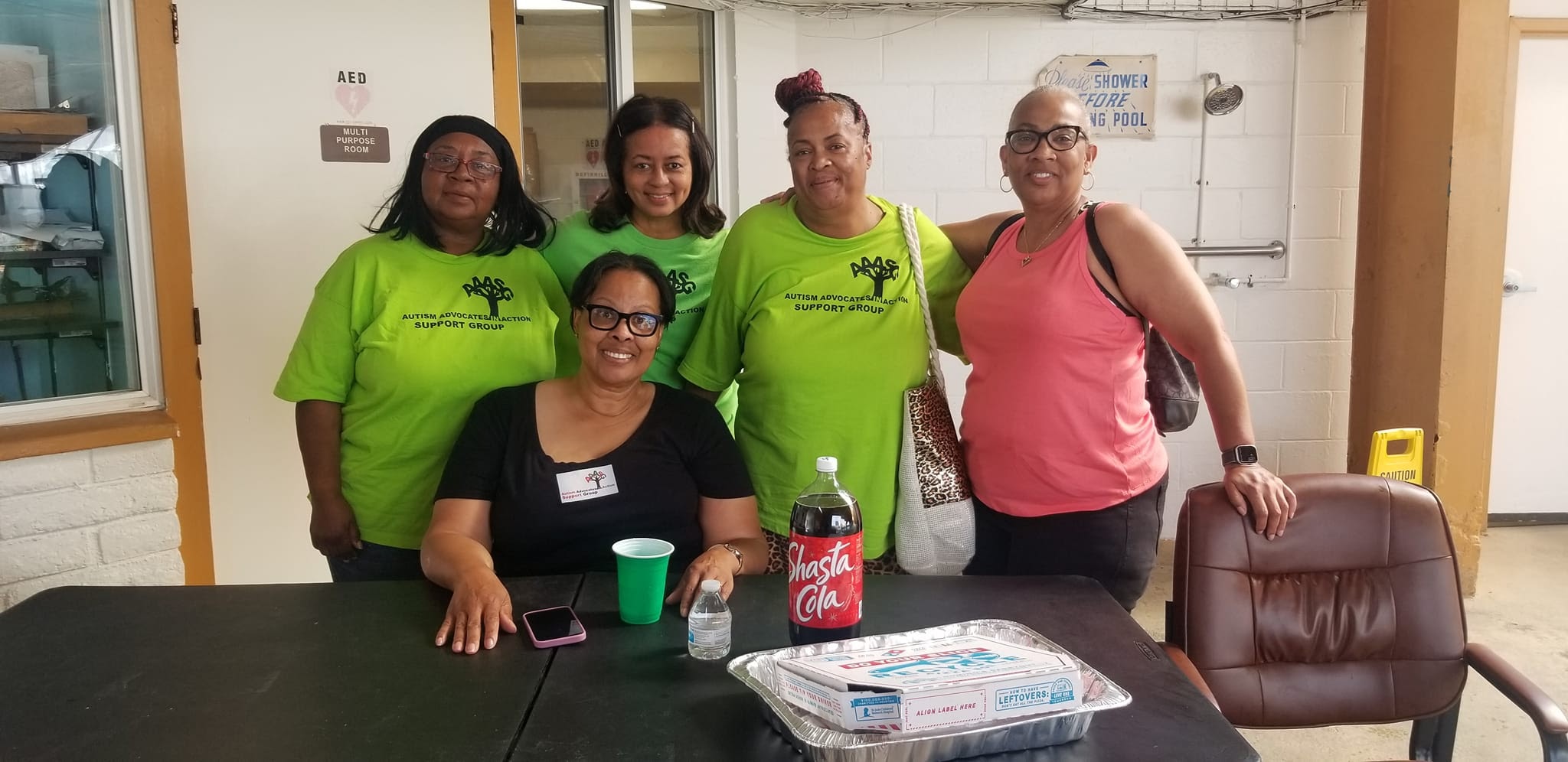 5 members of Autism Advocates in Action posing for a picture at an event